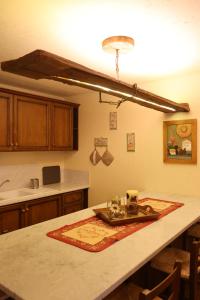 a kitchen with a table with a plate and glasses on it at Maison Rita e Cello in La Salle