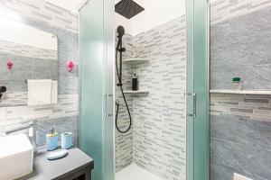 a bathroom with a shower with a glass door at Titi Rooms in La Spezia +34 photos