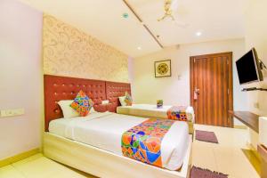 a hotel room with two beds and a television at Pentagon Next Bhubaneswar in Bhubaneshwar +15 photos