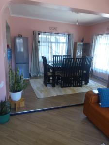 a living room with a floor vacuum at Cae Cozy Home in Karatu