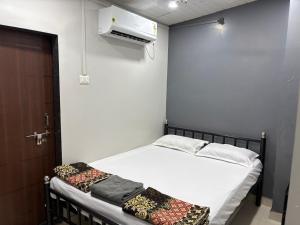 a small room with a bed and a heater at Datta Swami Homestay in Malvan