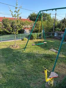 an empty swing set in a yard at Guest house Ivo in Lovran