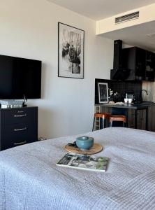 a room with a bed with a bowl on it at Baltic Infinity Suite 314 - SPA & Pool Access in Międzyzdroje