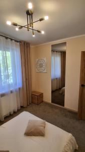 a bedroom with a bed and a large mirror at Umińskiego Spacious Apartment in Poznań
