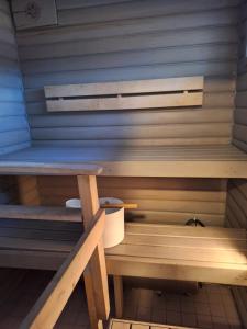 a sauna with a bench with a toilet in it at Saunamökki in Helsinki