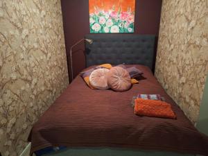 a bedroom with a bed with two pillows on it at Saunamökki in Helsinki