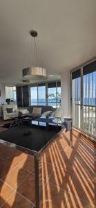 a living room with a couch and a table at Three Horizons Penthouse El Saler in Valencia