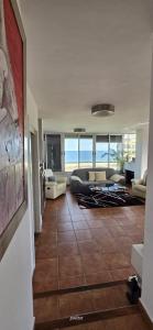 a living room with a couch and a table at Three Horizons Penthouse El Saler in Valencia