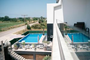 an external view of a house with a swimming pool at Capital Rooms in Ulcinj