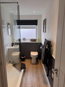 a bathroom with a toilet and a glass shower at The Lazy Fox, Shrewsbury in Shrewsbury +39 photos
