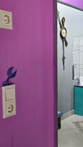 a purple door with a clock and a fish on it at Mermaid house in Drama +18 photos