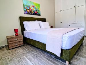a bedroom with a large bed and a dresser at Christina's Cottage in Agios Nikolaos