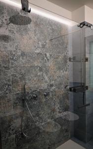a bathroom with a shower with a glass door at Lake Retreat in Anfo +17 photos