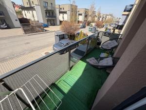 a balcony of a building with a green floor at Biby apartament in Cluj-Napoca