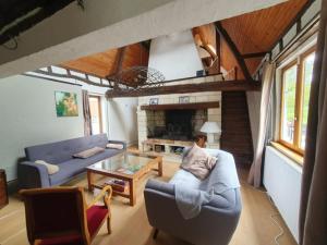 a living room with a couch and a table at Longère 'Nature et Baies' in Montigny