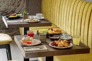 a breakfast table with plates of food and drinks at Fly Suite Rome Airport in Fiumicino +26 photos
