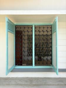 a window of a building with a glass at Achcha's Place in Negombo
