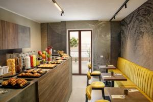 a restaurant with a buffet line with food on it at Fly Suite Rome Airport in Fiumicino