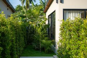 a house with trees and plants in the yard at Demaya Villa 5 in Ko Phangan