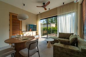 a living room with a table and a couch at Demaya Villa 5 in Ko Phangan