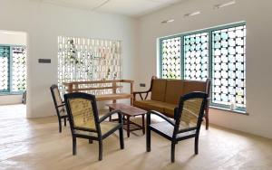 a room with a table and chairs and a couch at Achcha's Place in Negombo