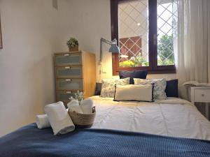 a bedroom with a bed with pillows and a window at Apartamento El Hayedo 20808 in Argoños
