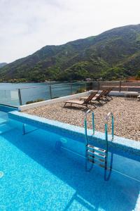 a swimming pool with a view of a mountain at Villa Morion with Sauna and Pool in Donji Morinj
