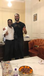 two men standing next to each other in a room at shangrila stay in Bodh Gaya