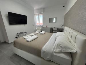 a bedroom with a large bed with towels on it at Milano Bicocca Apartment & Rooms2 in Cinisello Balsamo