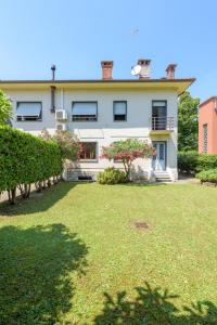 a house with a lawn in front of it at Scenarium in Udine