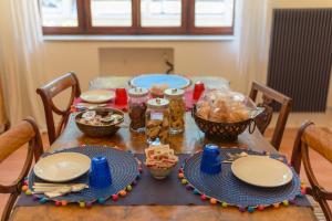 a table with plates and food on top of it at Scenarium in Udine