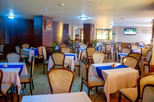 a dining room filled with tables and chairs with blue tables at Clarion Hotel Nairobi in Nairobi