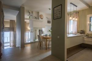 a kitchen and dining room with a table and chairs at Villa Morion with Sauna and Pool in Donji Morinj