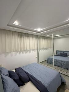 a bedroom with a bed and a large mirror at Sidi bou duplex in La Goulette