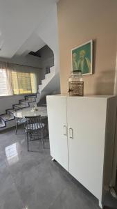 a room with a staircase and a table and chairs at Sidi bou duplex in La Goulette