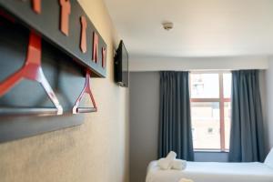 a hotel room with a bed and a window at easyHotel Sheffield in Sheffield