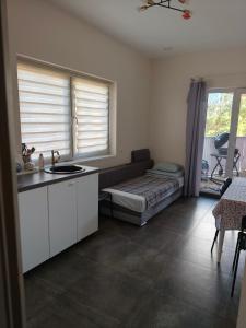 a kitchen with a couch and a bed in a room at Comfort Mile Apartments in Vilnius