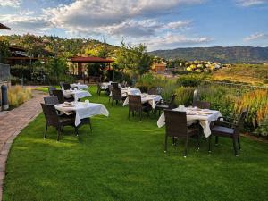 a restaurant with tables and chairs on the grass at Los Cinco Enebros Hotel & Spa by Bossh! Hotels in Robledo de Chavela