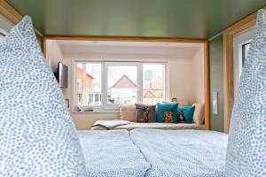 a bedroom with two beds and a window at Ilsehof Tiny-House Mimi in Osterwieck
