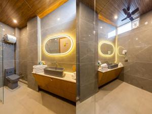 a bathroom with two sinks and a shower at yashobhoomi Hostel in New Delhi +46 photos