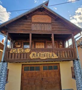 a building with a sign that reads csa karimiba at Casa Marinela in Haţeg