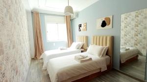 a bedroom with two beds and a window at Rami Home in Casablanca