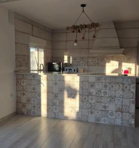 a kitchen with a counter top in a room at La Rocina in Sanlúcar de Barrameda +5 photos