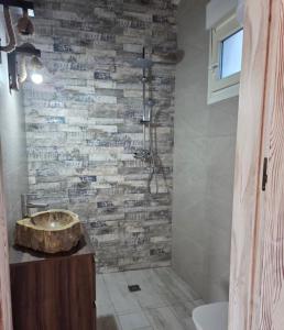 a bathroom with a sink and a stone wall at La Rocina in Sanlúcar de Barrameda
