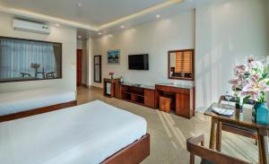 a hotel room with a bed and a bathroom at Song Nga Boutique Hotel Cat Ba in Cat Ba