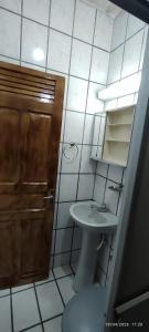 a bathroom with a toilet and a sink and a shower at Casa XV de novembro em Garanhuns in Garanhuns +4 photos