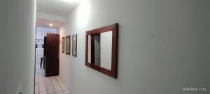 a hallway with a mirror on a wall at Casa XV de novembro em Garanhuns in Garanhuns