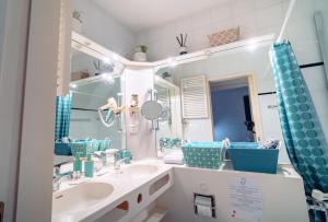 a bathroom with two sinks and a large mirror at Bissone Campione Lake Pool & Relax in Bissone +36 photos