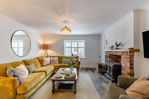 a living room with a couch and a fireplace at 4 Bed in Masham oc-w32087 in Masham