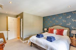 a bedroom with a bed with red pillows on it at 4 Bed in Masham oc-w32087 in Masham